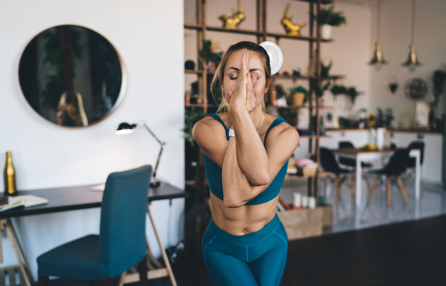Girl practicing yoga on fitness mat at home